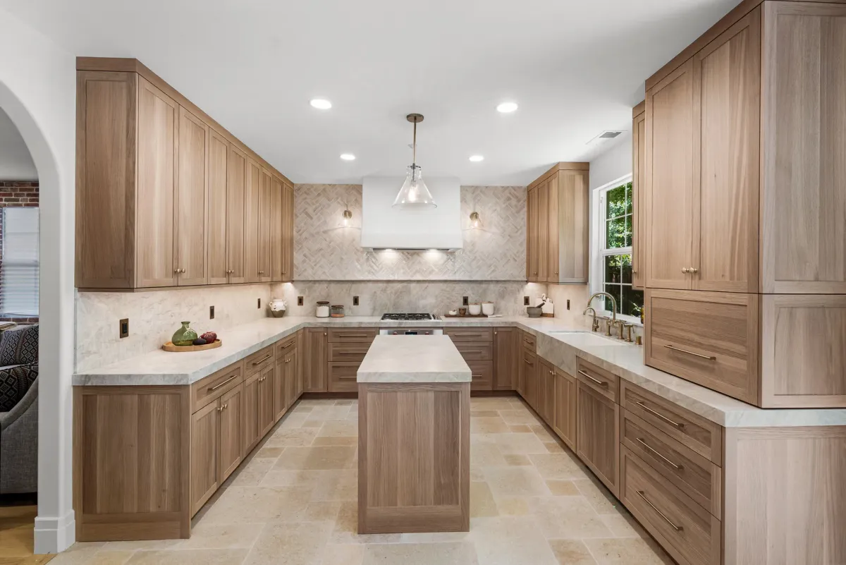 Remodeled kitchen with white oak cabinetry, stone island and arched doorway in a completed Dublin full home remodel by BayCraft