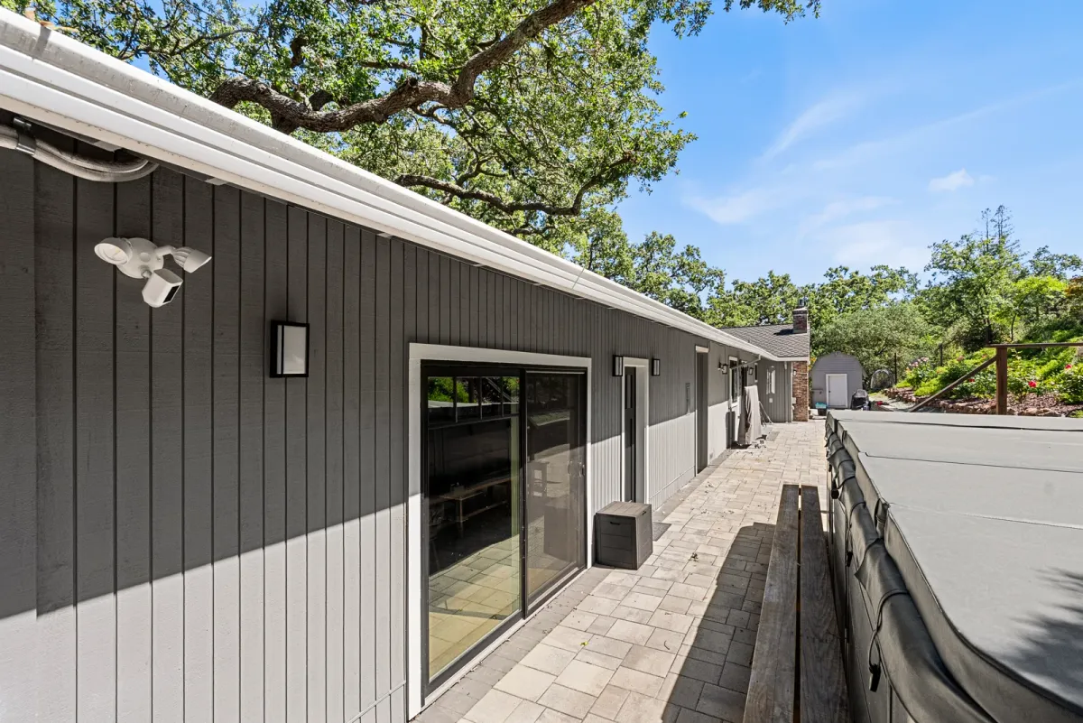 Side elevation with a sliding glass door opening onto the paver path