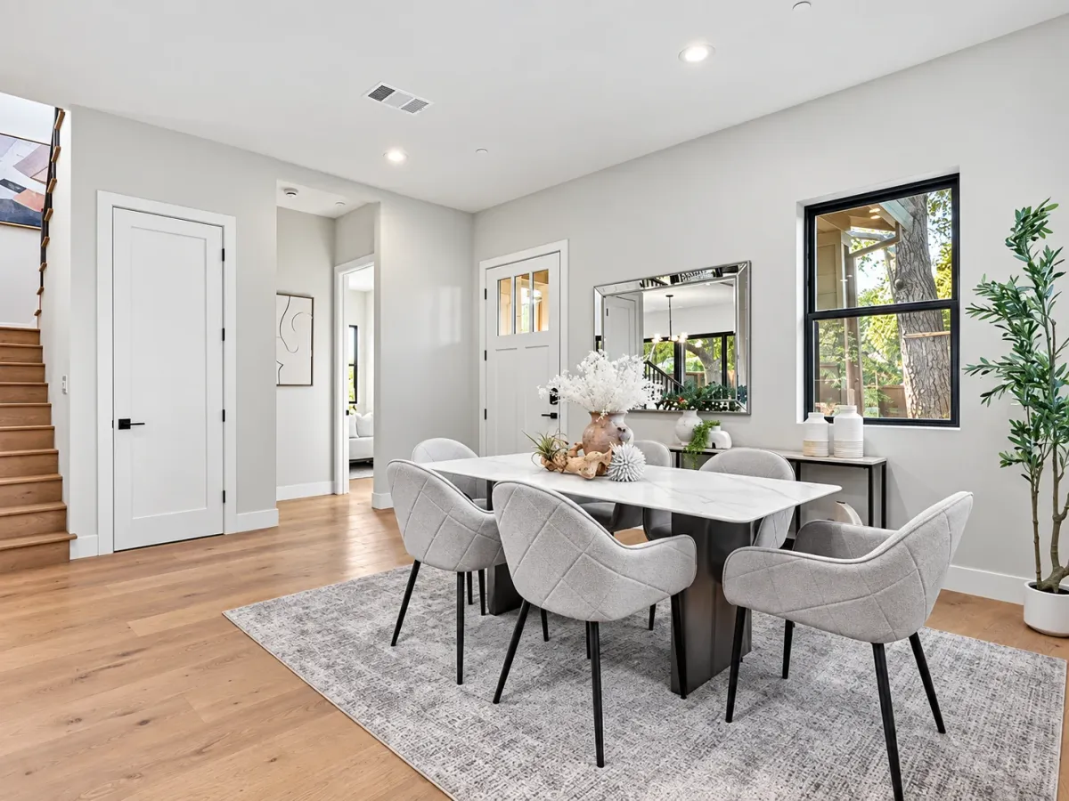 Dining area beside the entry, with the staircase and front door behind