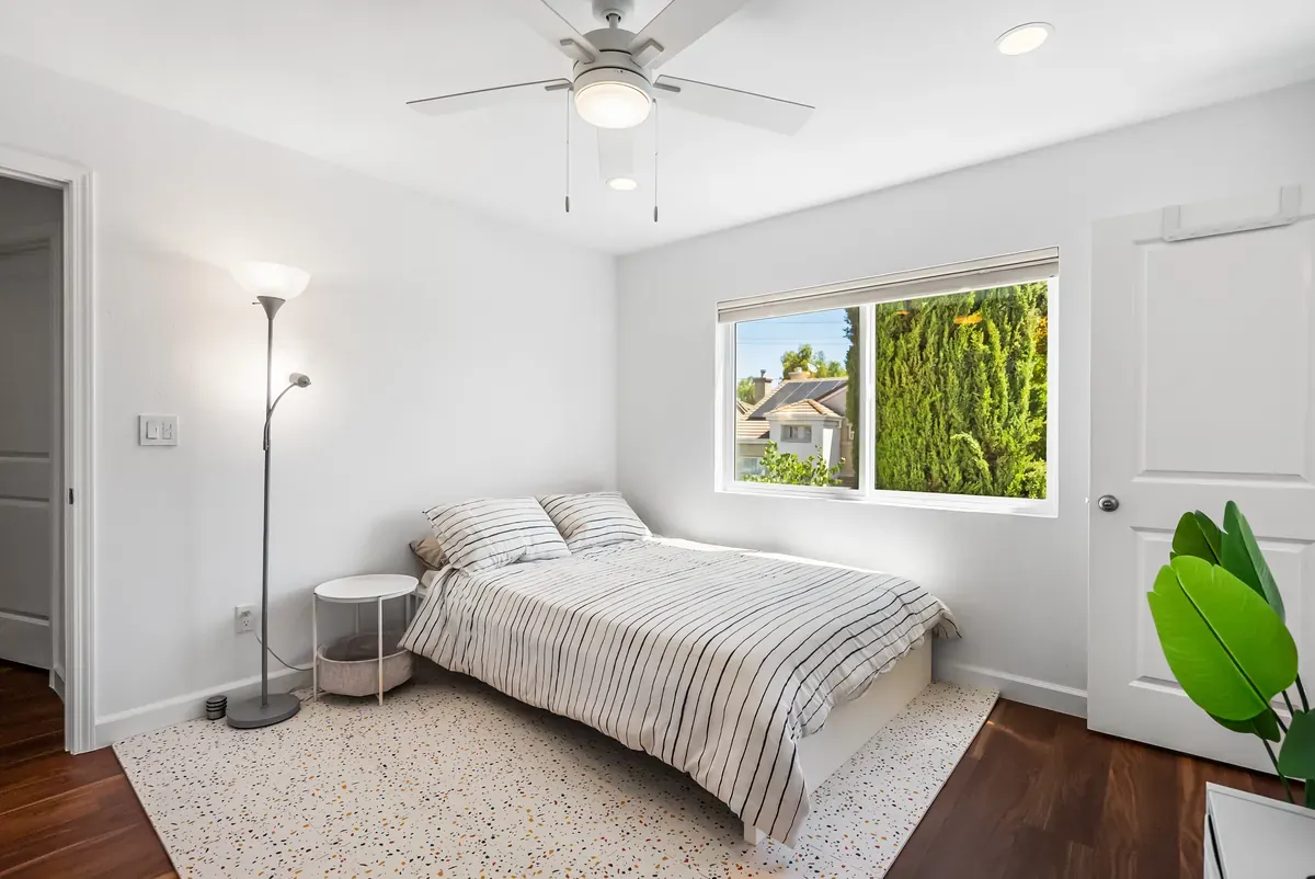 Bright bedroom with garden window, walnut floors and soft textiles